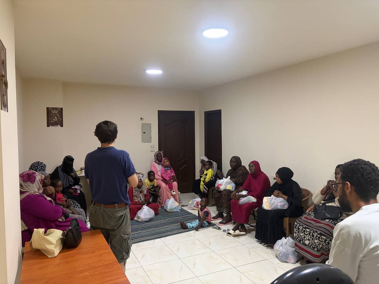 Sudanese refugee families gathered for humanitarian aid distribution