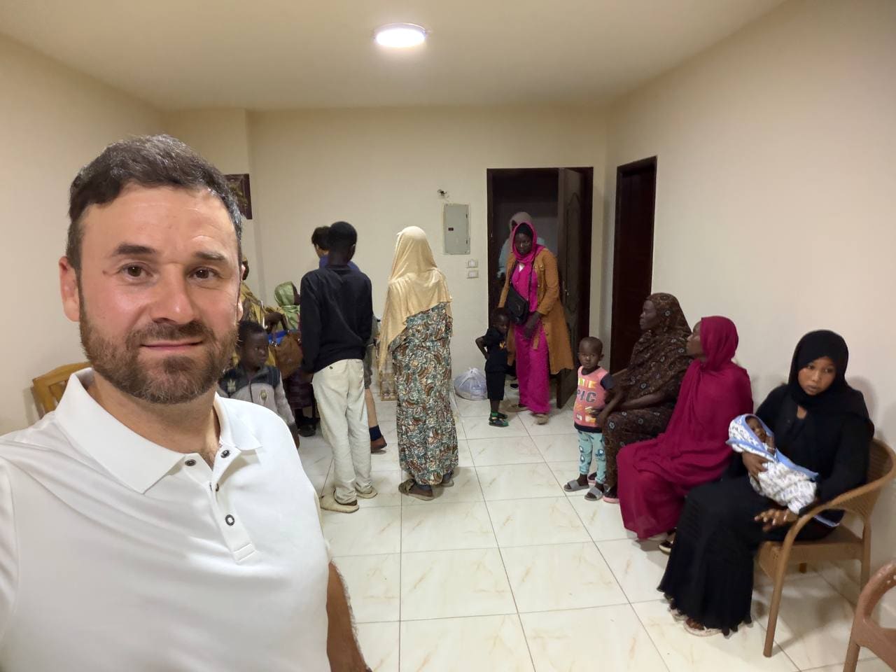 Sudanese refugee family receiving aid from mission team